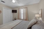 Queen bedroom with large flat screen tv and private closet